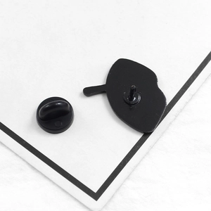Back view of black lip-shaped enamel pin showing metal pins and rubber clutch backings