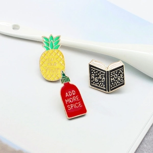 Three-piece set of cartoon enamel pins featuring pineapple, tomato sauce, and books theme