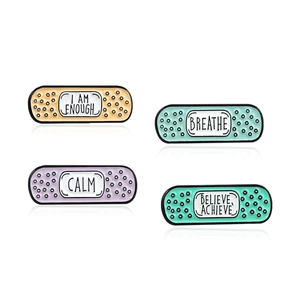 Set of four creative bandage enamel pins with motivational quotes on a white background