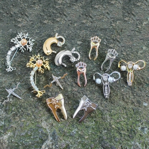 Creative medical brooches featuring crown tooth, kidney, and neuron designs with crystals