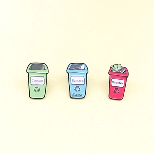 Three-piece enamel pin set showing green, blue and pink recycling bins with Russian text