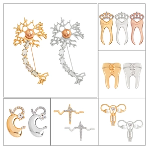 Creative medical pins set featuring golden teeth, heart, and organ designs with pearls