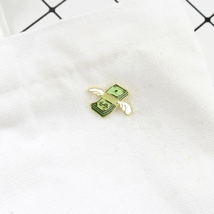 Creative flying dollar bill enamel brooch with wings and gold edges on white canvas