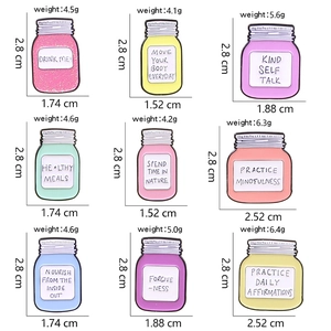 Detailed size chart showing nine colorful glass jar enamel pins with motivational quotes