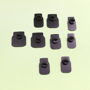 Detail of matte black mason jar silhouette brooch backs with rubber pin clutches
