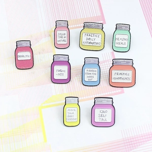 9-piece set of colorful enamel bottle pins with motivational English phrases for apparel