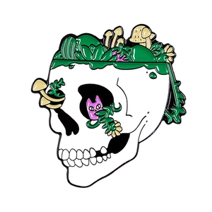 Enamel cat skull brooch with green succulents and yellow mushrooms in surreal art style
