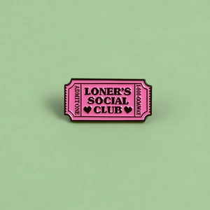 Pink Loner's Social Club enamel pin styled as a vintage ticket on a green background