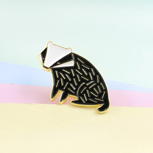 Cute cartoon badger enamel brooch with black and white geometric lines and gold trim