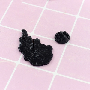 Detailed back view of a black enamel pin with textured surface and butterfly clutch