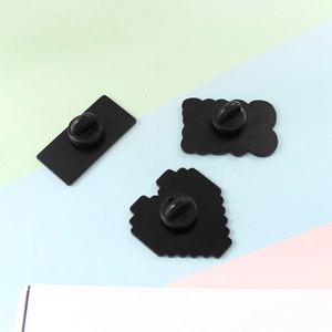 Three cartoon game controller enamel pins with black matte coating and rubber backings