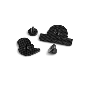 Black enamel turtle badges showing the metal back texture and various locking pin backs