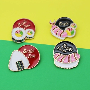 Set of four creative enamel pins featuring sushi and onigiri on a colorful background