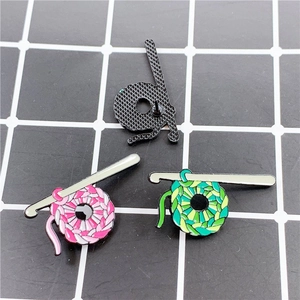 Handmade crochet yarn ball enamel pin badges in pink and green colors for craft lovers