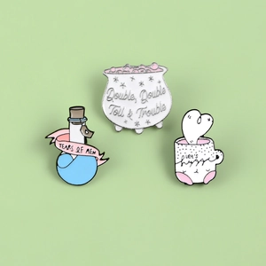 Creative enamel pins featuring heart coffee mug, witch cauldron, and magic bottle designs