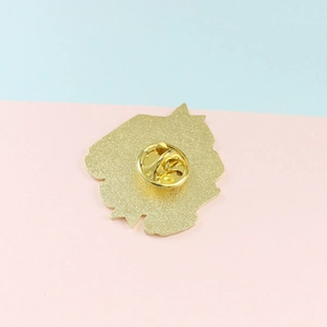 Back view of gold plated creative book brooch with a standard metal butterfly clutch pin