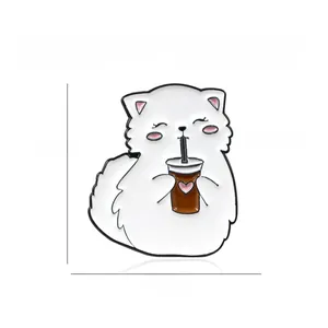Detail of cute white fat cat enamel pin made of eco-friendly alloy with heart drink