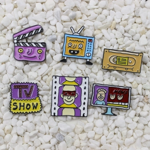 Retro TV show and film camera enamel pin set with tape and clapperboard designs