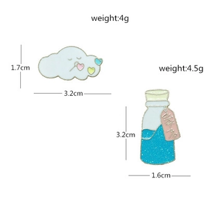 Detailed size view of cartoon cloud and glitter bottle enamel pins with dimensions