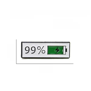 Macro detail of enamel battery pin showing 99 percent charge and lightning icon