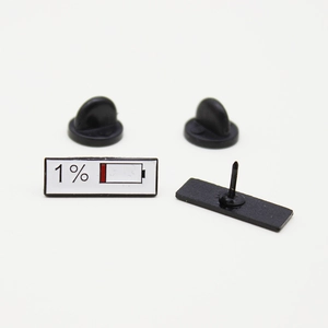 Detail showing the creative low battery enamel pins with black rubber clutch backings