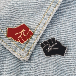 Creative red and black fist enamel pins set on denim fabric for team unity