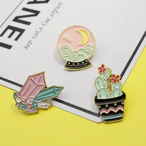 Three-piece enamel pin set with sun, moon, cactus, and crystal ball in gold metal finish