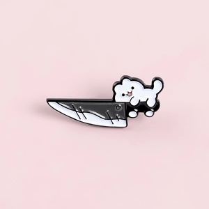 Cartoon white cat holding a large knife enamel pin on a soft pink background