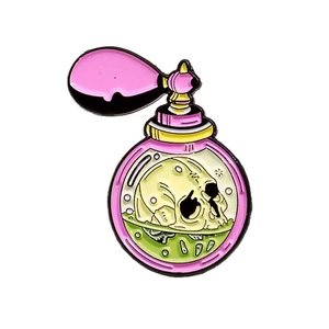 Gothic enamel pin featuring a mysterious perfume bottle with a skull and green liquid