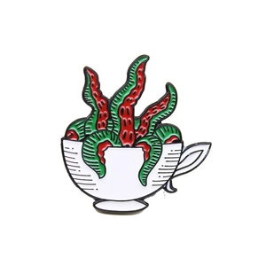 Creative enamel brooch featuring a red and green tentacle monster in a white tea cup