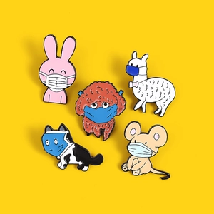 Set of five cartoon animal enamel pins wearing face masks on a bright yellow background