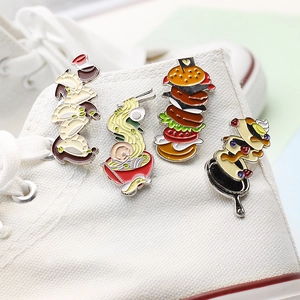 Creative food enamel pins set with burger and ramen on a white canvas sneaker