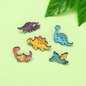 Set of 5 colorful cartoon dinosaur enamel pins featuring various cute prehistoric species