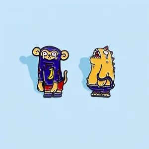 Cartoon enamel pin set with crying monkey and yellow monster on a blue background