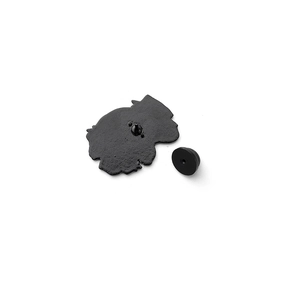 Detail view of black enamel pin back and rubber clutch closure on white background