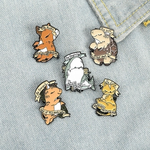 Set of 5 cartoon animal enamel pins with funny slogans on casual blue denim background