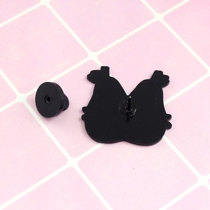 Detail view of the black rubber clutch and metal pin backing of the pear enamel badge