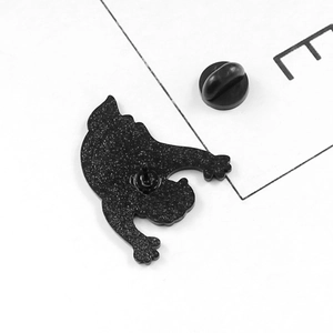 Detailed back view of a black enamel ghost pin showing the metal texture and rubber clutch