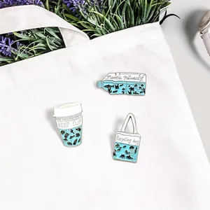 Three-piece eco-friendly enamel pin set with ocean themes on a white canvas bag
