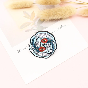 Creative koi fish enamel brooch with unique fantasy pattern and dancing tails on pink desk