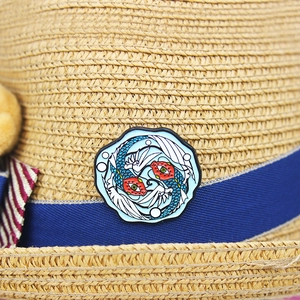 Creative enamel fish brooch with red and blue koi design on a straw hat ribbon decoration