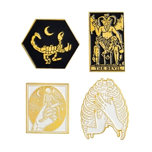 Gothic enamel brooch set featuring skull, scorpion, tarot devil, and ribcage designs