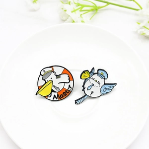 Cartoon pigeon and pelican enamel pins featuring pilot and master captain designs