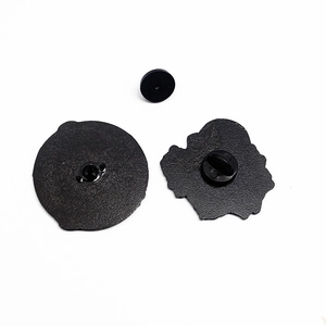 Detail of black metal badge back components with durable rubber pin clutch closure
