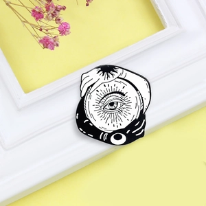 Mystic Yin Yang sun and moon enamel brooch with hands holding a crystal ball eye