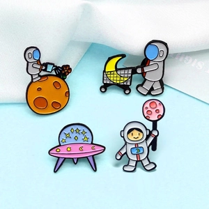 Set of 4 astronaut enamel pins featuring space motifs like UFO moon and flowers