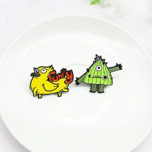 Funny cartoon yellow bird and green monster enamel pins set for creative fashion styling