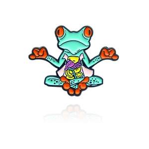 Cartoon meditating anatomy frog enamel pin badge with vibrant green and orange details