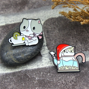 Cute enamel cat pins featuring a cat with lemon tea and a cat in a teapot with pearls