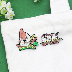 Cartoon mother bird reading and baby birds on cherry branch enamel brooch set on canvas